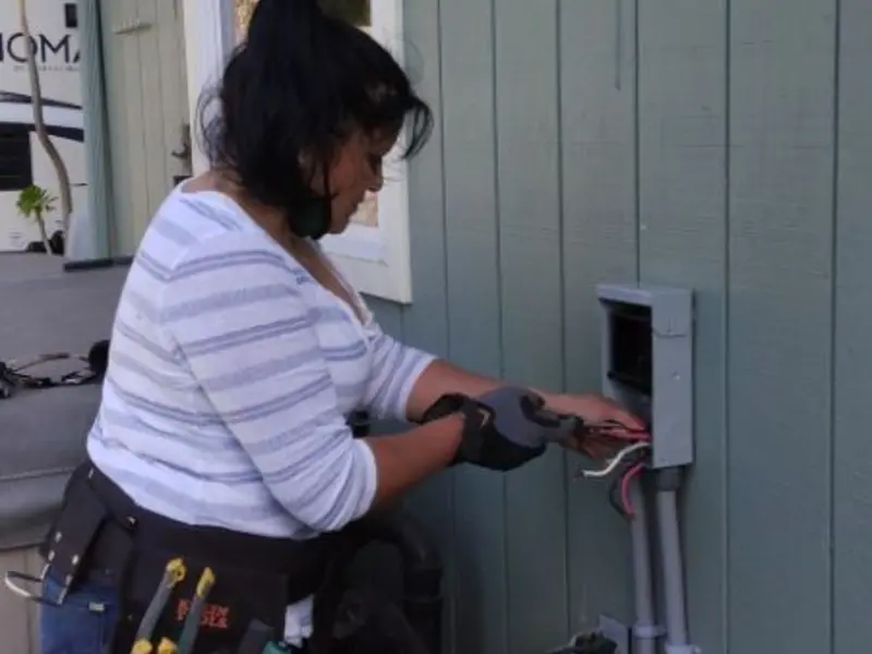Licensed electrician wiring an exterior subpanel in Desert Palms